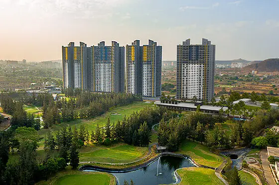 Blue Ridge Hinjewadi towers above the township lake at golden hour